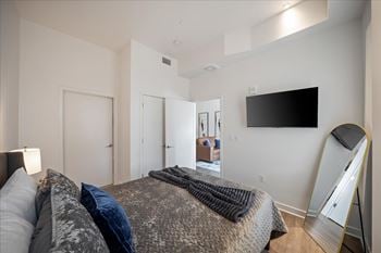 Furnished apartment bedroom with television at sky on main